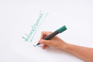 advertisement. a female hand writing on a white paper writes a hand.