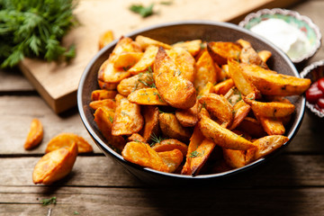 Baked potato fries on wooden table