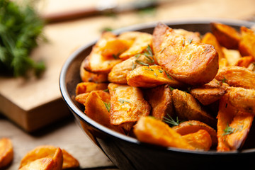 Baked potato fries on wooden table