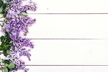 Lilac flowers on white wooden background. Copy space.