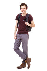 Full length cool college student with earphones listening to music