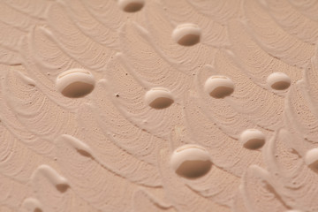 Light beige makeup smear of creamy foundation