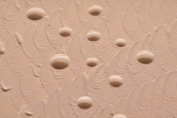 Light beige makeup smear of creamy foundation