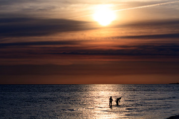 Couple in the sea, time before the sunset