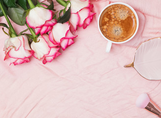 Coffee and roses on the pink cloth background