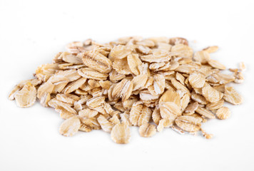 pile of oatmeal isolated on white background. Creative layout made of organic oatmeal isolated on white background. Food concept.