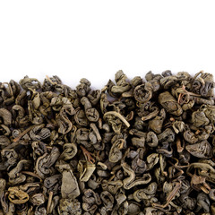 Oolong tea To Guanine in round shape isolated. Green tea background. Dry Green Tea Leaves isolated on White Background