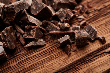 crumbs of black chocolate on a wooden background