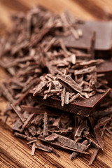 crumbs of black chocolate on a wooden background