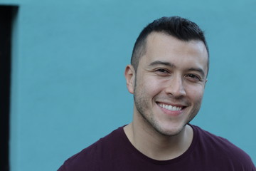 Cute ethnic man smiling with copy space