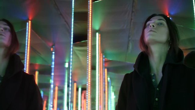 Girl is going through the columns of lights