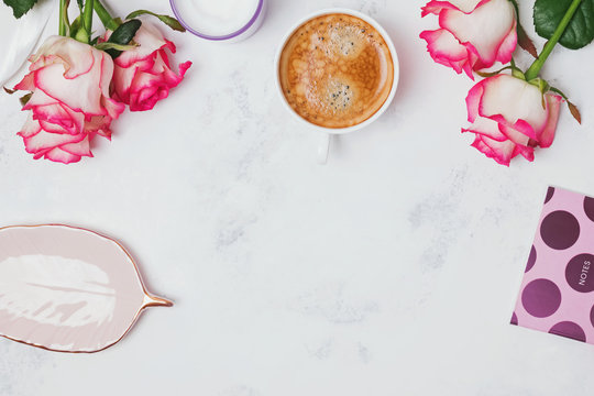 Roses and coffee on the marble background