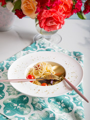 Spaghetti pasta with cherry tomatoes on white plate