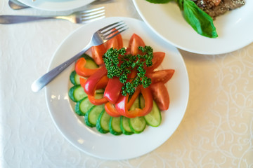 Plate with served fresh vegetables.