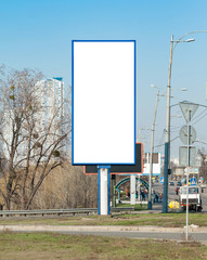 Blank vertical billboard near a highway.