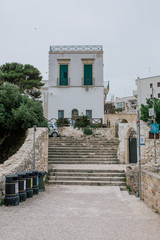 Trash bin for sorting Stone stairs in Polignano a Mare apulia Italy