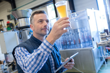 brewer inspecting the beer