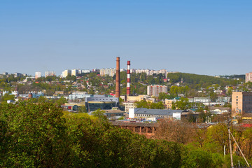 Factory pipes in the background of the summer city