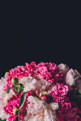 festive pink peony bouquet, isolated on black with copy space