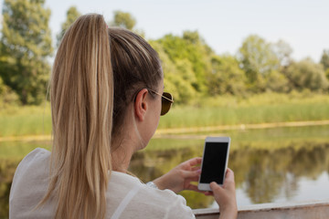 Young woman using smart phone outdoor.