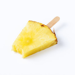 Pineapple on ice cream stick on white background. Minimal concept.