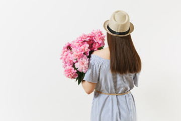 Young tender woman in blue dress, hat holding bouquet of beautiful pink peonies flowers isolated on white background. St. Valentine's Day, International Women's Day holiday concept. Advertising area.