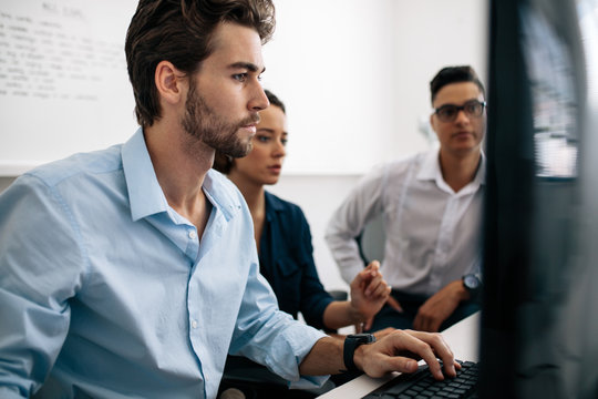 Application developers working on computers in office
