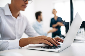 Application developers working on computers in office