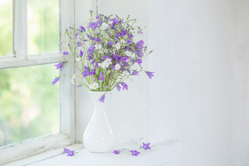 bluebells in vase on windowsill