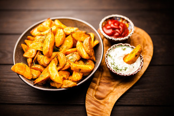 Baked potato fries on wooden table