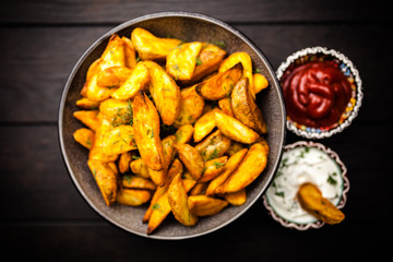 Baked potato fries on wooden table
