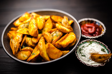Baked potato fries on wooden table