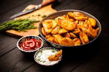 Baked potato fries on wooden table