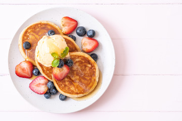 pancake with blueberries, strawberries, honey and vanilla ice-cream - obrazy, fototapety, plakaty
