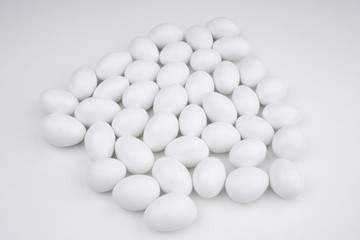 Small white candy on a white background