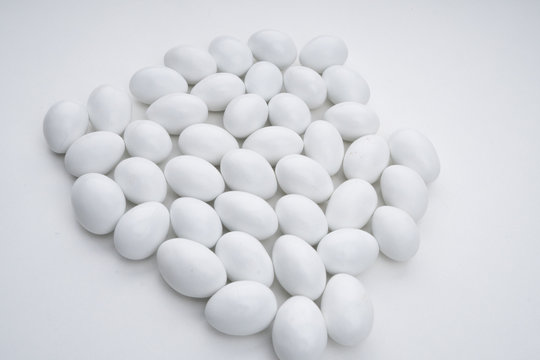 Small white candy on a white background