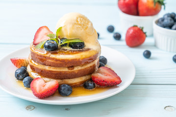 pancake with blueberries, strawberries, honey and vanilla ice-cream