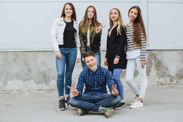 Summer holidays and teenage concept - group of smiling teenagers with skateboard hanging out...