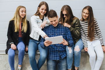 Summer holidays and teenage concept - group of smiling teenagers with skateboard hanging out...