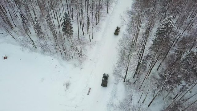 Military armored personnel carriers in the woods during military exercises. Clip. Top view of military armored personnel carriers in the forest in winter