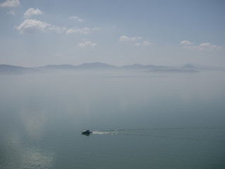 Fog over Lake Trasimeno on a peaceful morning, Umbria