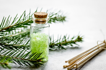 spa with organic spruce sea salt in glass bottles on white table