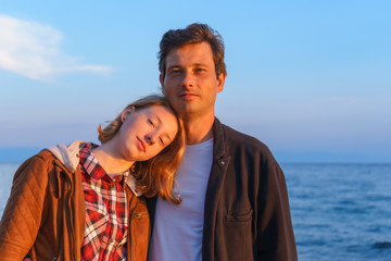 Portraits of father and daughter in the summer at sunset on the