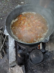 shurpa in a large cauldron in the open air