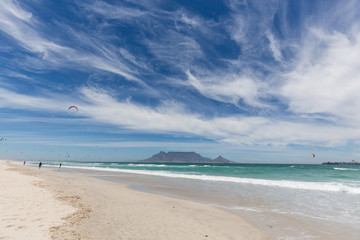 View of Table Mountain from Blouberg in Cape Town with wind surfers