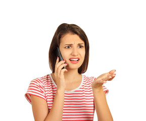 beautiful young woman with dark wavy hair looks frustrated and bewilderment while talking on the...
