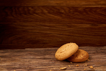 Pile of oat cookies on wooden table, close-up, selective focus.