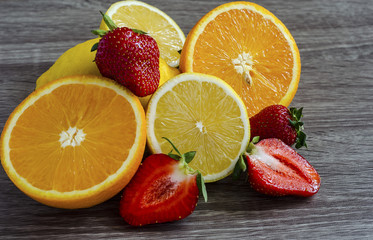 Obraz na płótnie Canvas strawberry lemon and orange cut