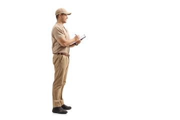 Delivery man writing in a clipboard and looking away