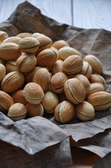 Russian dessert - nuts from short pastry with a filling of boiled condensed milk, with the addition of whole walnuts and hazelnuts